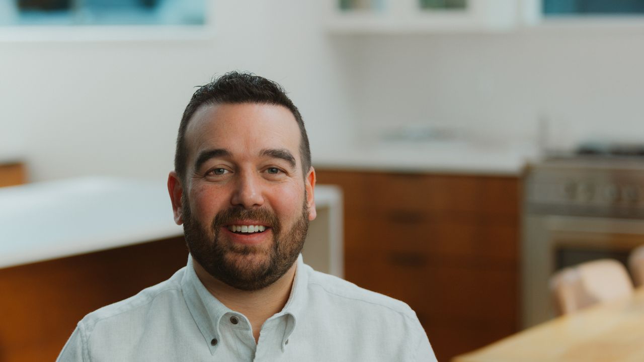 Justin Miller, smiling, in a bright kitchen